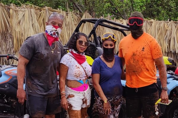 a group photo in front of an offroad vehicle n the Dominican Republic